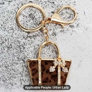 NWT animal print, Gold, purse keychain/bag charm.
